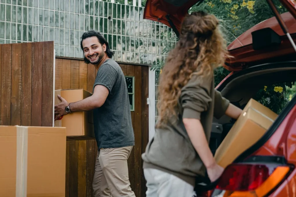 couple moving boxes on summer day