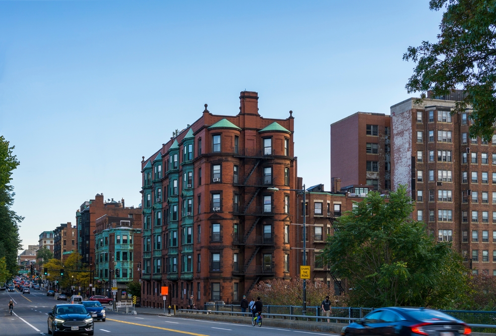 Historic brownstone apartments next to a road in a Boston neighborhood