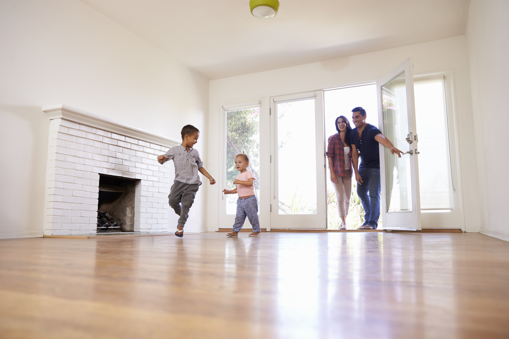 A family walking into their new empty home