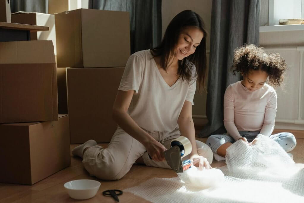 mother and daughter packing for a move